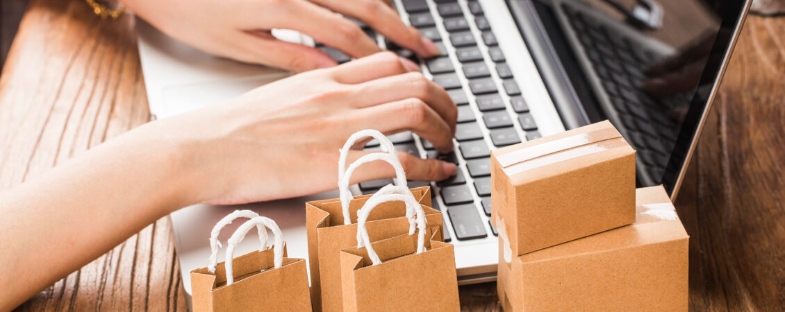 shopping-online-at-home-concept-cartons-in-shopping-cart-on-laptop-keyboard